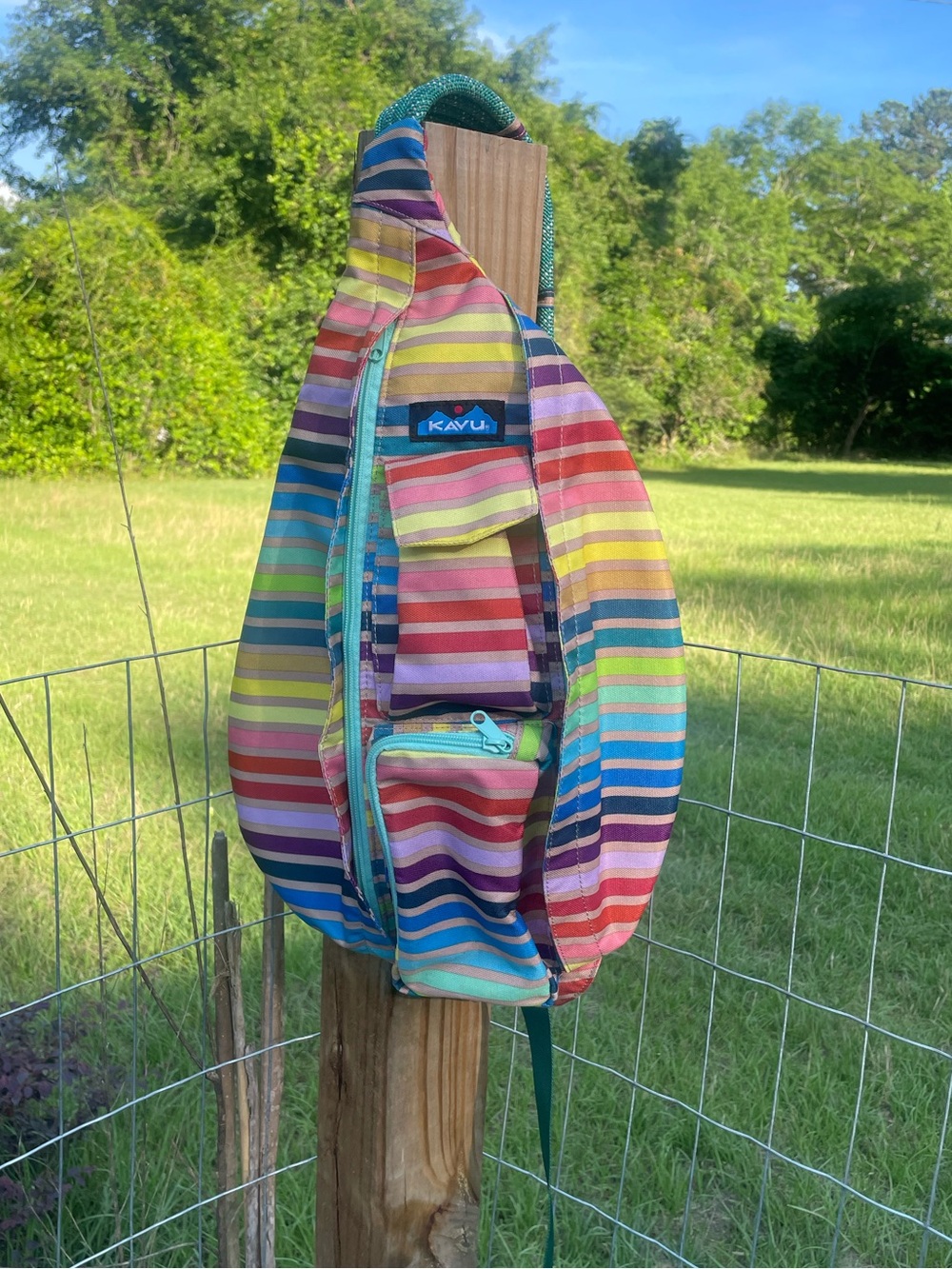 KAVU Rope Sling bag in the vibrant "Chroma Stripe" pattern.